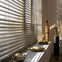 Aluminium venetian blind slats angled against warm afternoon light