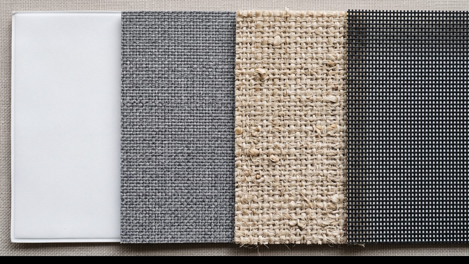 Four roller blind fabric swatches edge to edge showing PVC, polyester, natural weave and sunscreen mesh
