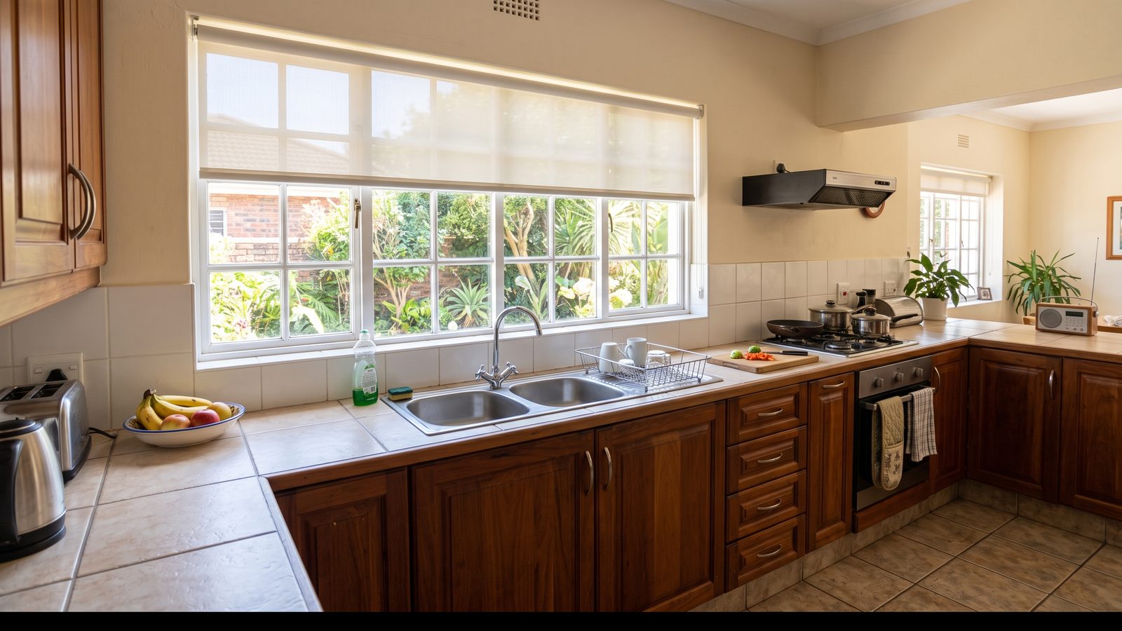 Easy-clean PVC roller blind above a tiled counter